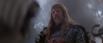 Movie still from “Conan the Barbarian” (1982), directed by John Milius – A person wearing a costume; Close Up shot, Low angle