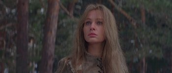 Movie still from “Conan the Barbarian” (1982), directed by John Milius – A woman with long brown hair and blue eyes looking into the distance; Close Up shot, Low angle
