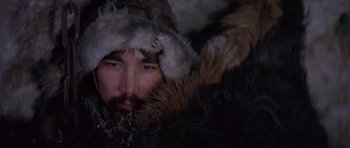 Movie still from “Conan the Barbarian” (1982), directed by John Milius – A man with a beard wearing a fur coat and a hat; Close Up shot, Overhead angle