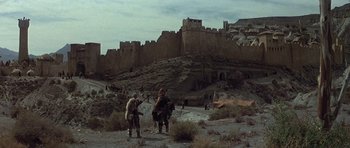 Movie still from “Conan the Barbarian” (1982), directed by John Milius – Two men are standing in the middle of the desert; Extreme Wide shot, Low angle