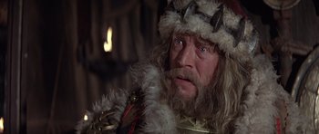 Movie still from “Conan the Barbarian” (1982), directed by John Milius – A man with a beard and a crown on; Close Up shot, Low angle