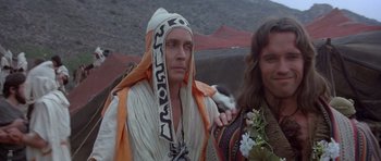 Movie still from “Conan the Barbarian” (1982), directed by John Milius – A man wearing a robe and a hood; Close Up shot, Low angle