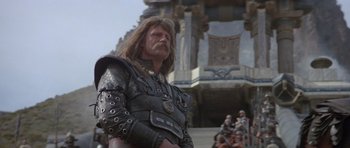 Movie still from “Conan the Barbarian” (1982), directed by John Milius – A man dressed as a roman soldier in a movie scene; Medium shot, Low angle