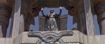 Movie still from “Conan the Barbarian” (1982), directed by John Milius – An image of a person standing on top of a building; Wide shot, Low angle