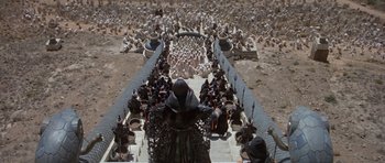 Movie still from “Conan the Barbarian” (1982), directed by John Milius – A group of people standing in a field; Extreme Wide shot, High angle
