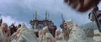 Movie still from “Conan the Barbarian” (1982), directed by John Milius – A group of people dressed in costumes and holding weapons; Wide shot, Low angle