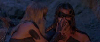 Movie still from “Conan the Barbarian” (1982), directed by John Milius – A woman covering her face with her hands and another woman covering her face with her hands and another woman covering her face with her hands; Medium shot, Over the shoulder angle