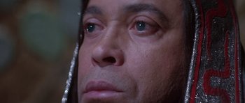 Movie still from “Conan the Barbarian” (1982), directed by John Milius – A man's face with blue eyes; Extreme Close Up shot, High angle