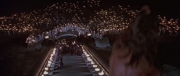 Movie still from “Conan the Barbarian” (1982), directed by John Milius – A group of people standing in a field with candles; Extreme Wide shot, High angle