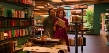 Movie still from “Big Bug” (2022), directed by Jean-Pierre Jeunet – A man and a woman standing in a library; Medium shot, Over the shoulder angle