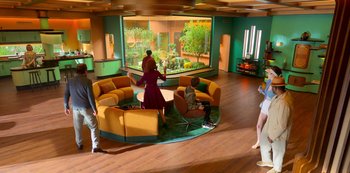 Movie still from “Big Bug” (2022), directed by Jean-Pierre Jeunet – A group of people standing in a room with furniture; Extreme Wide shot, High angle