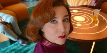 Movie still from “Big Bug” (2022), directed by Jean-Pierre Jeunet – A person wearing a purple shirt; Close Up shot, High angle