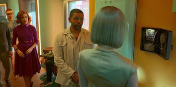A man and a woman are standing in front of a mirror
