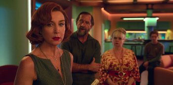 Movie still from “Big Bug” (2022), directed by Jean-Pierre Jeunet – A woman standing next to a man and a woman; Medium shot, Over the shoulder angle