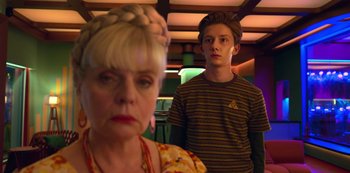 Movie still from “Big Bug” (2022), directed by Jean-Pierre Jeunet – A woman and a boy standing next to each other in a room; Close Up shot, Over the shoulder angle