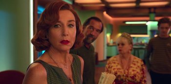 Movie still from “Big Bug” (2022), directed by Jean-Pierre Jeunet – A woman standing next to a man and a woman; Close Up shot, Over the shoulder angle