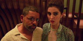 Movie still from “Big Bug” (2022), directed by Jean-Pierre Jeunet – A man and a woman standing next to each other in front of a wall; Close Up shot, Low angle