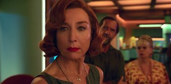 Movie still from “Big Bug” (2022), directed by Jean-Pierre Jeunet – A person wearing a necklace; Close Up shot, Over the shoulder angle