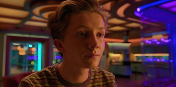 Movie still from “Big Bug” (2022), directed by Jean-Pierre Jeunet – A young man is looking into the camera; Close Up shot, Over the shoulder angle