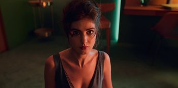 Movie still from “Big Bug” (2022), directed by Jean-Pierre Jeunet – A person wearing a dress; Close Up shot, High angle