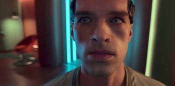 Movie still from “Big Bug” (2022), directed by Jean-Pierre Jeunet – A man's face with blue light in the background; Close Up shot, Overhead angle