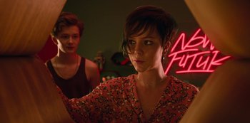 Movie still from “Big Bug” (2022), directed by Jean-Pierre Jeunet – A woman looking into a mirror while another woman looks on; Close Up shot, Over the shoulder angle