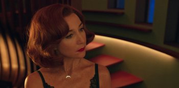 Movie still from “Big Bug” (2022), directed by Jean-Pierre Jeunet – A person sitting on a chair; Close Up shot, Over the shoulder angle