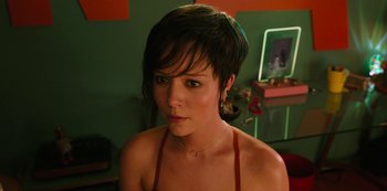 Movie still from “Big Bug” (2022), directed by Jean-Pierre Jeunet – A person with short black hair; Close Up shot, Over the shoulder angle