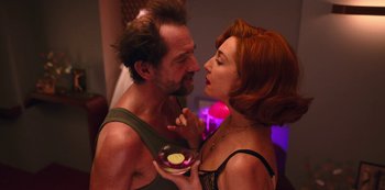 Movie still from “Big Bug” (2022), directed by Jean-Pierre Jeunet – A man and a woman are holding a bowl of food; Close Up shot, Low angle