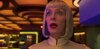 Movie still from “Big Bug” (2022), directed by Jean-Pierre Jeunet – A woman with blonde hair and green eyes looking surprised; Close Up shot, Low angle