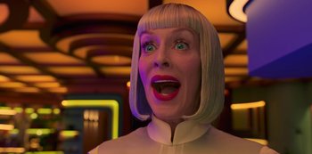 Movie still from “Big Bug” (2022), directed by Jean-Pierre Jeunet – A woman with blonde hair and red lipstick; Close Up shot, Low angle