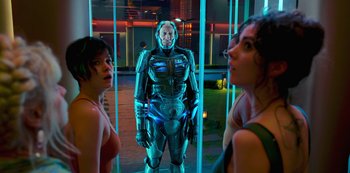 Movie still from “Big Bug” (2022), directed by Jean-Pierre Jeunet – Two women and a man are standing next to each other in front of a glass wall; Medium shot, Low angle