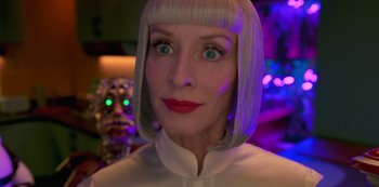 Movie still from “Big Bug” (2022), directed by Jean-Pierre Jeunet – A woman with blonde hair and green eyes; Close Up shot, Low angle