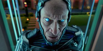 Movie still from “Big Bug” (2022), directed by Jean-Pierre Jeunet – An old man with blue eyes and a helmet on; Close Up shot, Low angle
