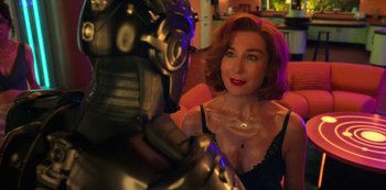 Movie still from “Big Bug” (2022), directed by Jean-Pierre Jeunet – A red haired woman sitting next to a robot; Close Up shot, Over the shoulder angle