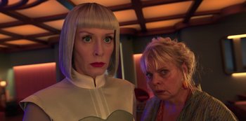 Movie still from “Big Bug” (2022), directed by Jean-Pierre Jeunet – A woman in a white dress and a woman in a green dress; Close Up shot, Low angle