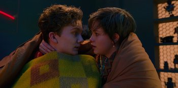 Movie still from “Big Bug” (2022), directed by Jean-Pierre Jeunet – A man and a woman are snuggled up together; Close Up shot, High angle