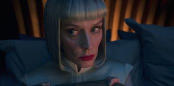 Movie still from “Big Bug” (2022), directed by Jean-Pierre Jeunet – A person wearing a white suit; Close Up shot, Low angle