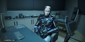 Movie still from “Big Bug” (2022), directed by Jean-Pierre Jeunet – An old man sitting at a table in a room; Medium shot, High angle