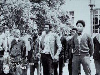 Movie still from “Da 5 Bloods” (2020), directed by Spike Lee – A black and white photo of a group of men; Medium shot, Low angle