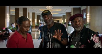 Movie still from “Da 5 Bloods” (2020), directed by Spike Lee – A group of men standing next to each other in a room; Medium shot, High angle