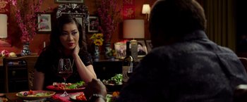 Movie still from “Da 5 Bloods” (2020), directed by Spike Lee – A woman sitting at a dinner table with a man; Close Up shot, Over the shoulder angle