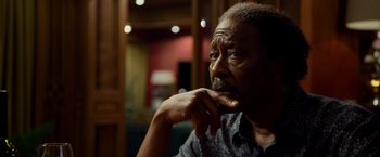 Movie still from “Da 5 Bloods” (2020), directed by Spike Lee – An older man sitting in front of a wooden wall; Close Up shot, Over the shoulder angle