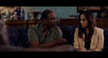 Movie still from “Da 5 Bloods” (2020), directed by Spike Lee – A man and a woman sitting on a couch talking; Close Up shot, Over the shoulder angle