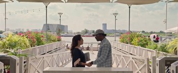 Movie still from “Da 5 Bloods” (2020), directed by Spike Lee – A man and a woman shaking hands on a bridge; Medium shot, Over the shoulder angle