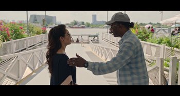 Movie still from “Da 5 Bloods” (2020), directed by Spike Lee – A man and a woman talking on a pier; Medium shot, Over the shoulder angle