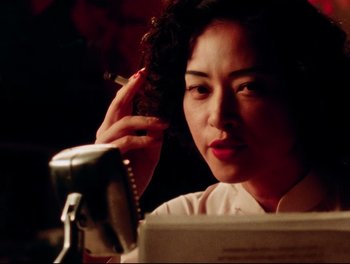 Movie still from “Da 5 Bloods” (2020), directed by Spike Lee – A woman is sitting in front of a computer; Close Up shot, Low angle