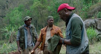 Movie still from “Da 5 Bloods” (2020), directed by Spike Lee – A group of men standing next to each other on top of a hill; Medium shot, Over the shoulder angle