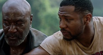 Movie still from “Da 5 Bloods” (2020), directed by Spike Lee – Two men sitting next to each other in a forest; Close Up shot, Over the shoulder angle