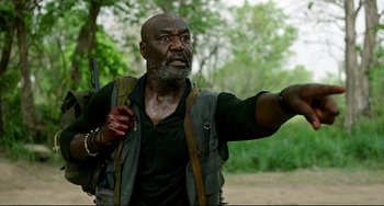 Movie still from “Da 5 Bloods” (2020), directed by Spike Lee – An older man holding a gun and pointing to the ground; Close Up shot, Low angle
